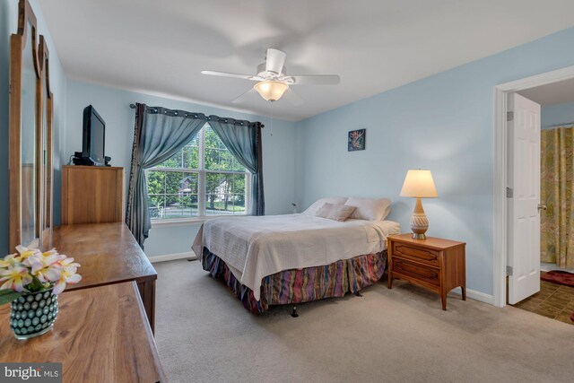 carpeted bedroom with baseboards and ceiling fan