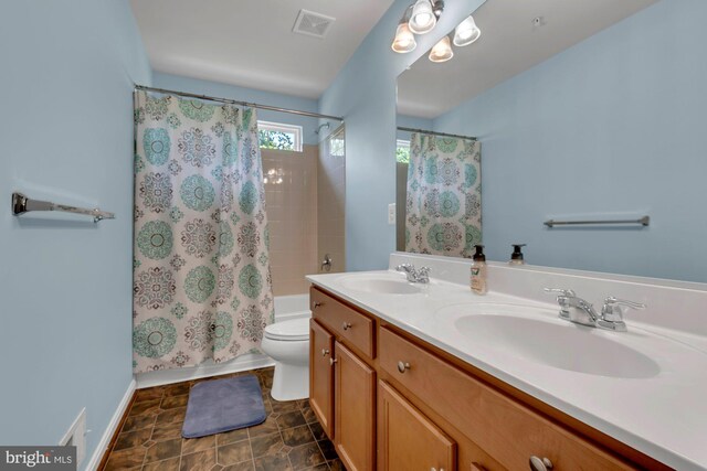 full bath featuring visible vents, a sink, shower / bath combination with curtain, and toilet