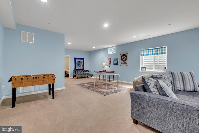 carpeted living area featuring baseboards, recessed lighting, and visible vents