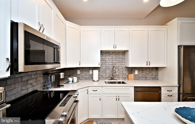 kitchen with white cabinetry, appliances with stainless steel finishes, and a sink