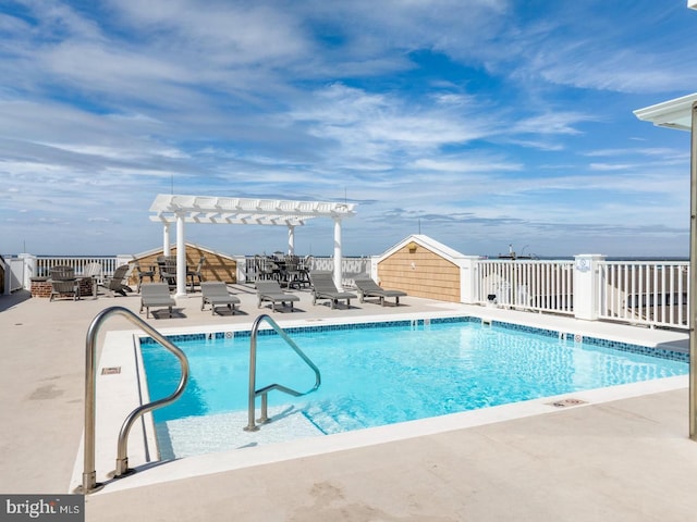 community pool with fence, a pergola, and a patio area
