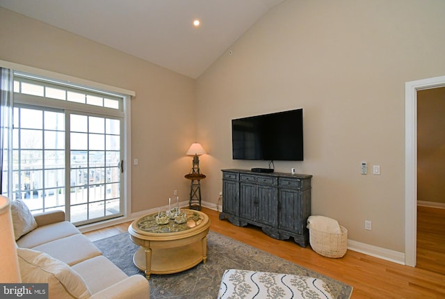 living room featuring recessed lighting, baseboards, wood finished floors, and high vaulted ceiling