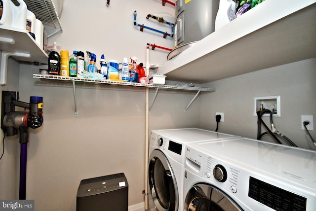 laundry room with washing machine and clothes dryer and laundry area