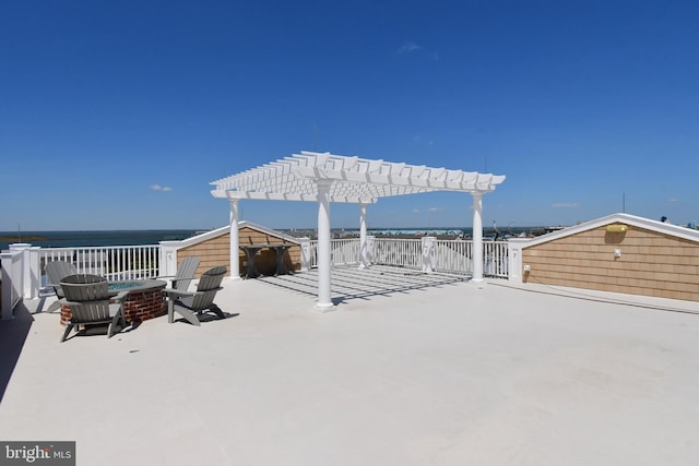 view of patio featuring a pergola, a fire pit, and a water view