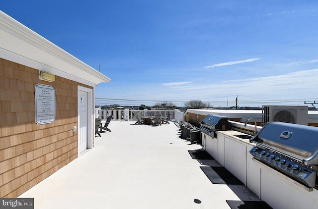 view of patio / terrace with a sink, ac unit, and area for grilling