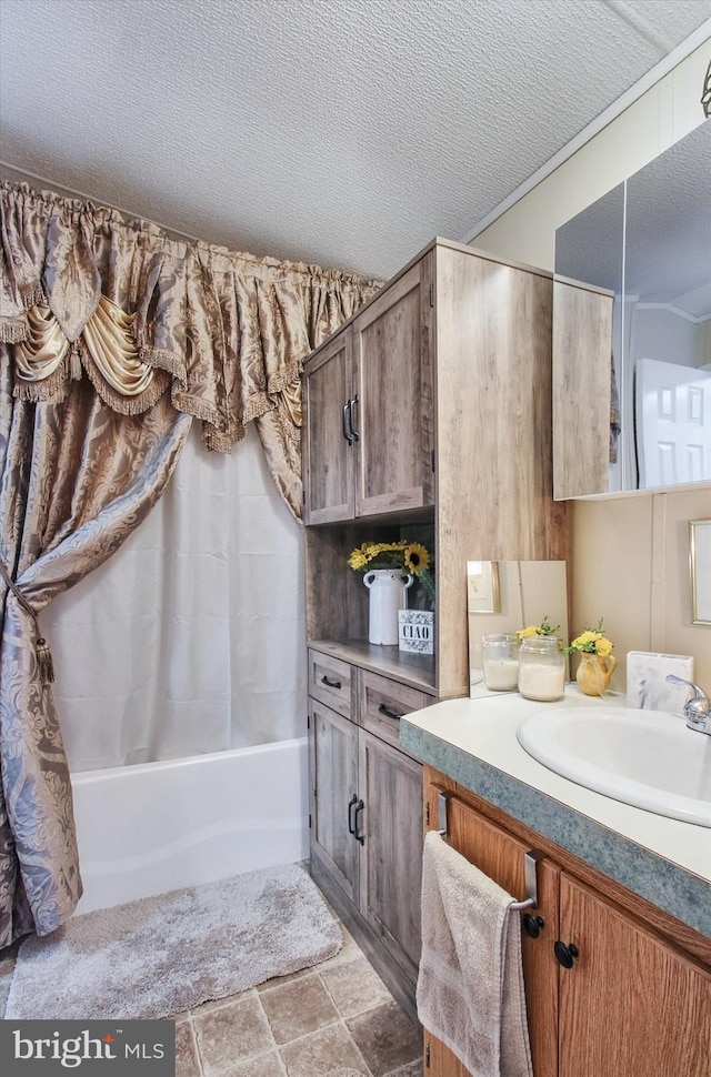 bathroom with a textured ceiling and vanity