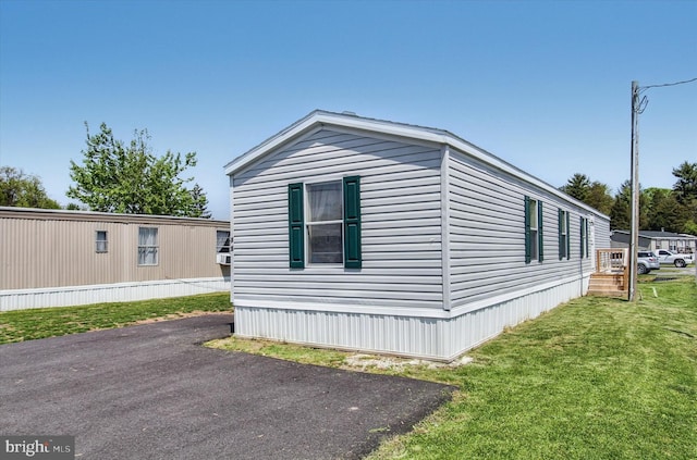 view of side of home with a lawn