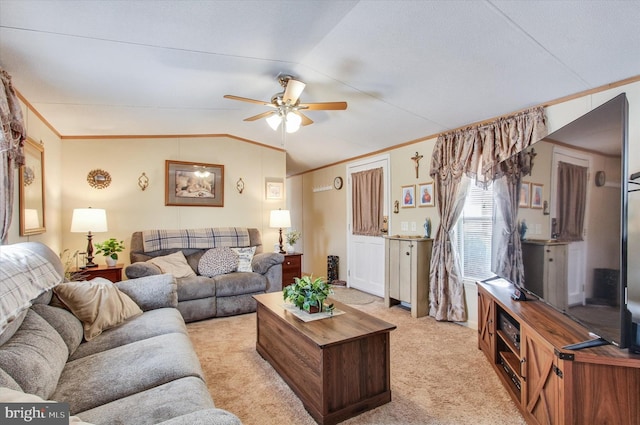living room featuring crown molding, vaulted ceiling, a ceiling fan, and light carpet