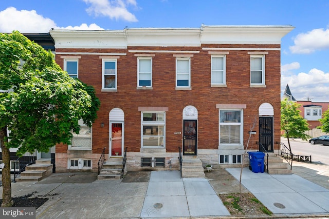 townhome / multi-family property featuring brick siding
