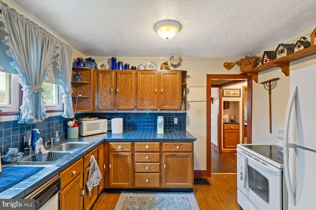 621 Gay St, Hanover, PA 17331 - kitchen featuring open shelves, white appliances, a sink, brown cabinets, and a textured ceiling
