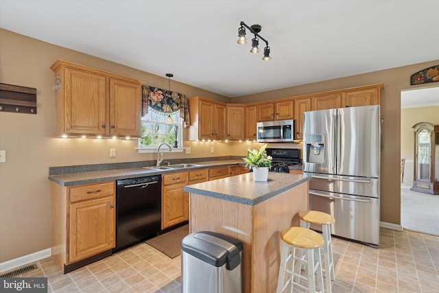 kitchen with a kitchen breakfast bar, baseboards, a sink, and black appliances