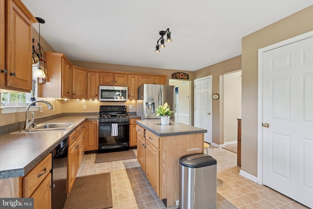 kitchen featuring dark countertops, light floors, a center island, a sink, and black appliances