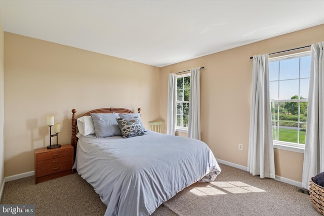 carpeted bedroom with baseboards and visible vents