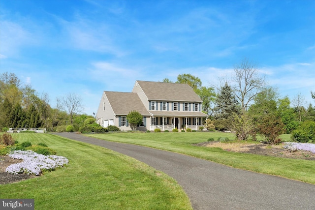 colonial home with a front lawn