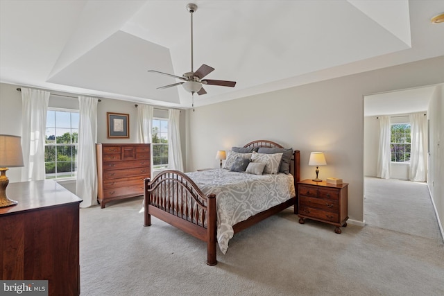 bedroom with ceiling fan and light carpet