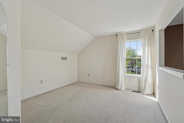bonus room featuring carpet floors, baseboards, lofted ceiling, and visible vents