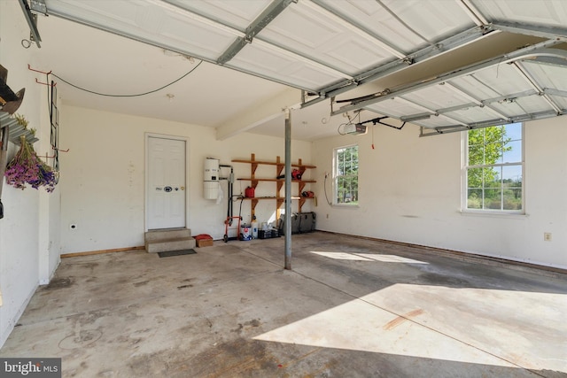 garage with baseboards and a garage door opener