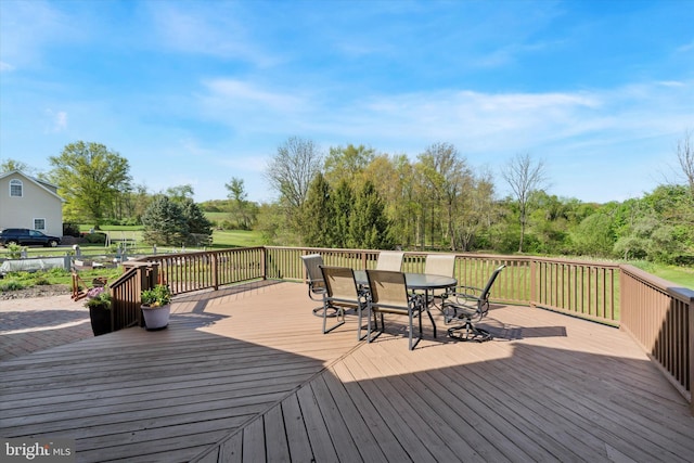 wooden terrace featuring outdoor dining space