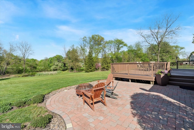 view of patio / terrace with a wooden deck and an outdoor fire pit