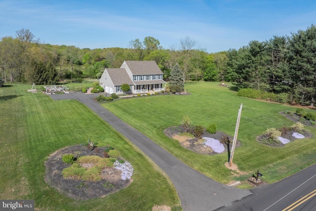drone / aerial view featuring a wooded view