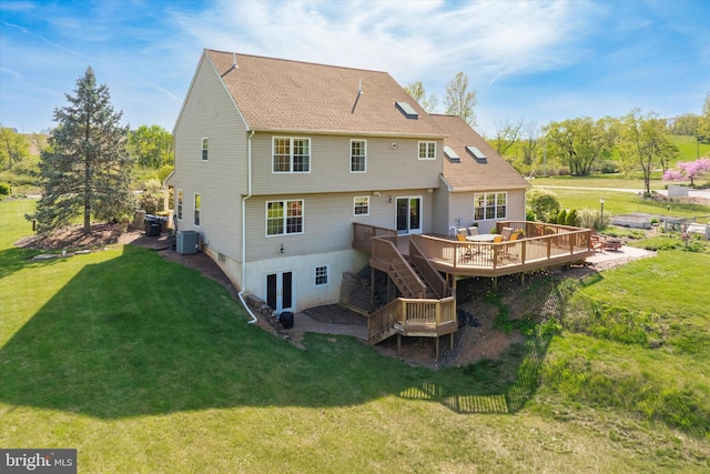 back of property featuring stairway, a deck, cooling unit, french doors, and a yard