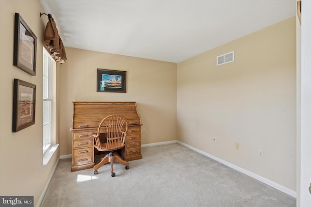 carpeted office featuring baseboards and visible vents