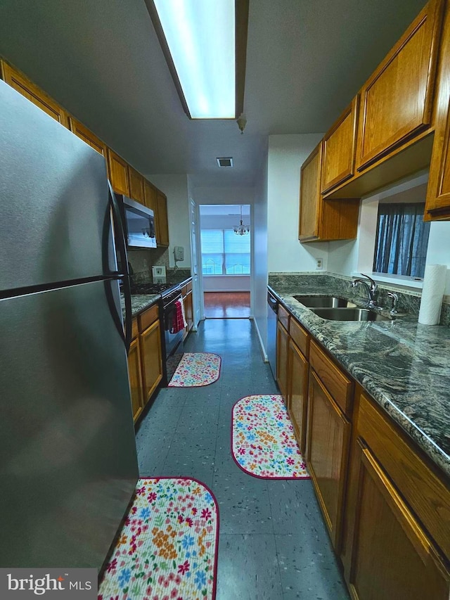 6620 Lake Park Dr Unit 2D 201, Greenbelt, MD 20770 - kitchen featuring a sink, stainless steel appliances, brown cabinetry, and dark floors