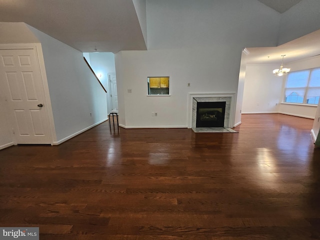 6620 Lake Park Dr Unit 2D 201, Greenbelt, MD 20770 - unfurnished living room with a chandelier, a premium fireplace, dark wood-style flooring, and baseboards