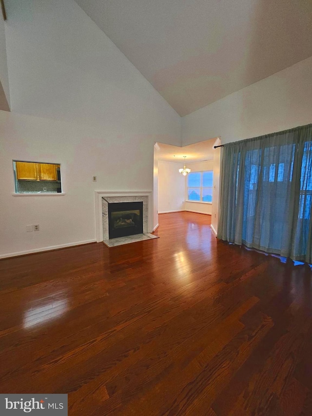 6620 Lake Park Dr Unit 2D 201, Greenbelt, MD 20770 - unfurnished living room with a chandelier, wood finished floors, a premium fireplace, baseboards, and high vaulted ceiling