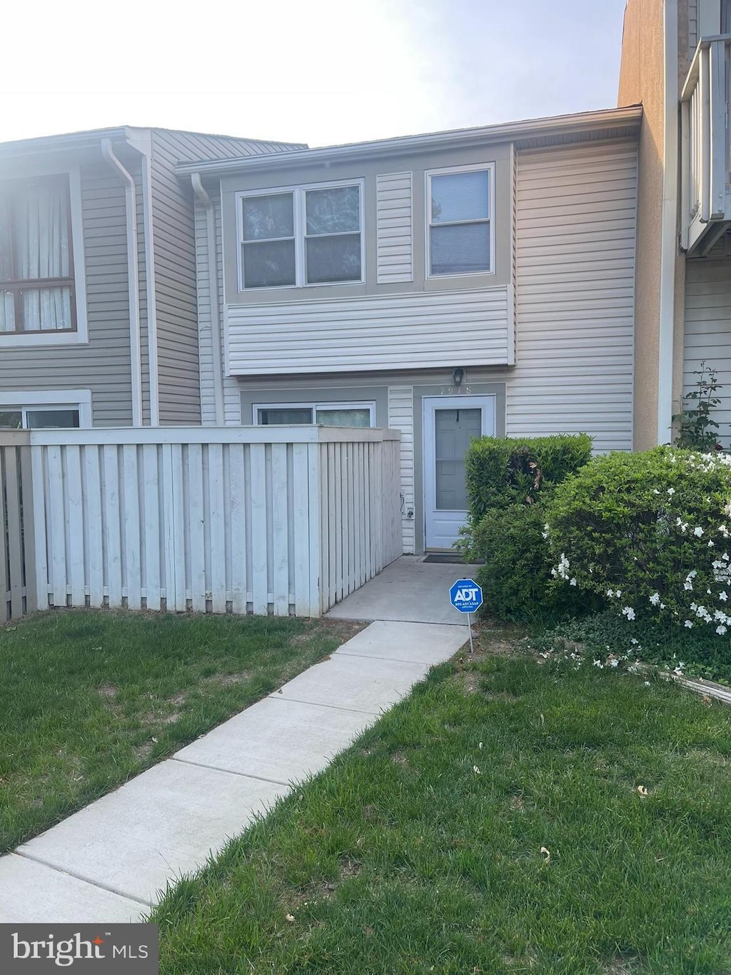 view of property featuring fence and a front yard
