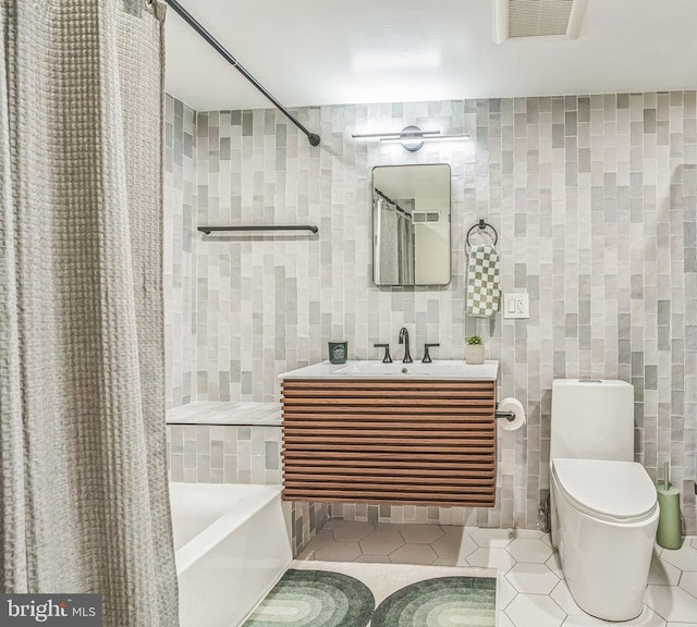 2019 Pemberton St, Philadelphia, PA 19146 - bathroom featuring tile walls, tile patterned flooring, toilet, vanity, and shower / bath combo