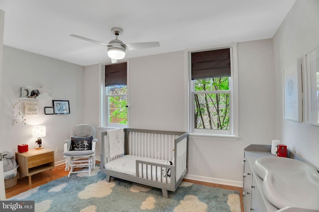 2019 Pemberton St, Philadelphia, PA 19146 - bedroom with multiple windows, a crib, wood finished floors, and baseboards