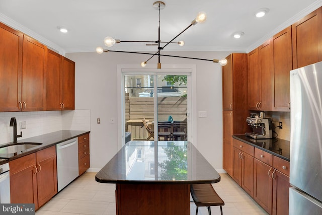 2019 Pemberton St, Philadelphia, PA 19146 - kitchen featuring stainless steel appliances, a sink, a chandelier, tasteful backsplash, and ornamental molding