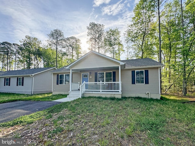 ranch-style home featuring a porch and a front yard