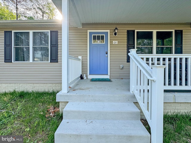 doorway to property with covered porch