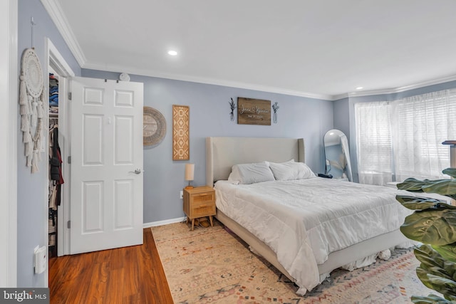 bedroom featuring crown molding, recessed lighting, baseboards, and wood finished floors