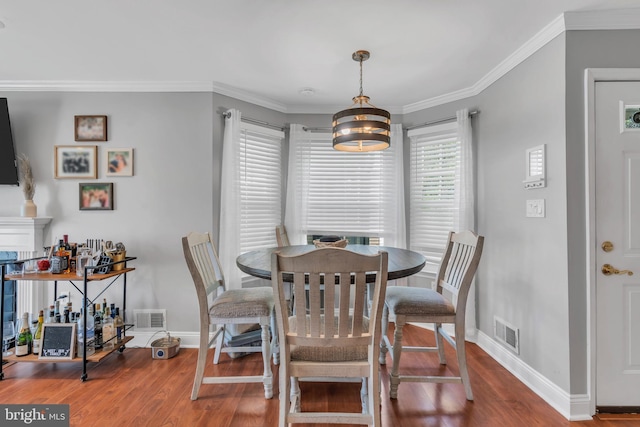 dining space with visible vents, baseboards, and wood finished floors