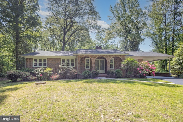 single story home with an attached carport, brick siding, and a front yard