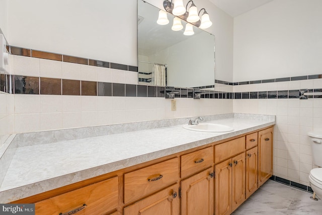 full bathroom featuring tile walls, vanity, toilet, and marble finish floor