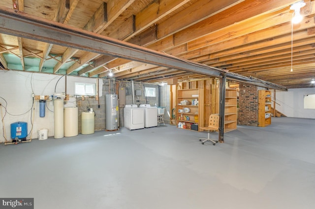 basement featuring washer and clothes dryer and electric water heater