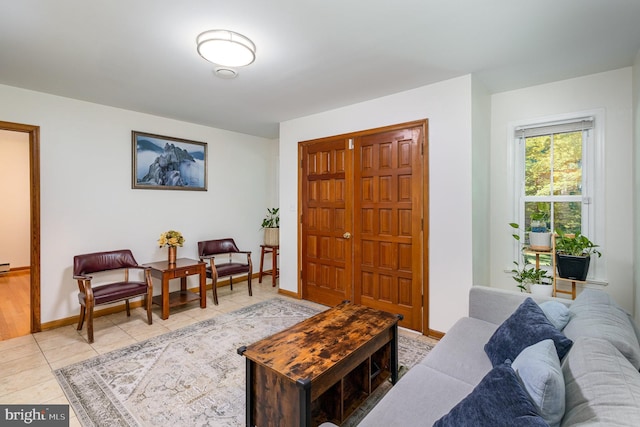 living area with tile patterned floors and baseboards