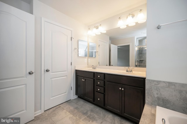 full bath featuring double vanity, a washtub, a sink, and tile patterned flooring