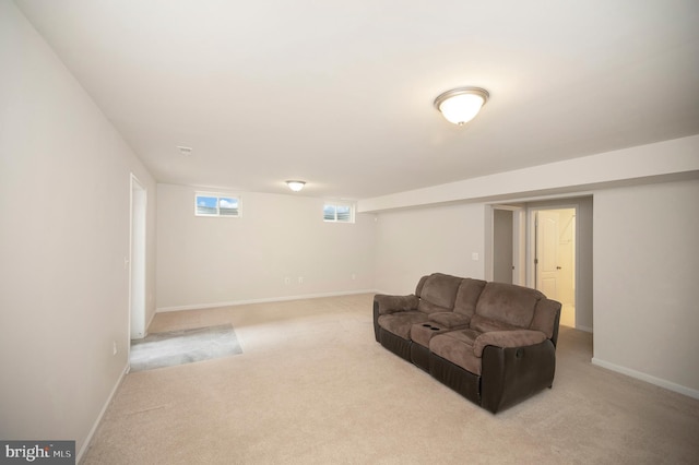 living area with baseboards, light carpet, and visible vents
