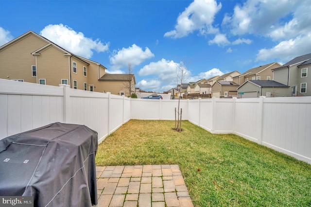 view of yard with a fenced backyard and a residential view