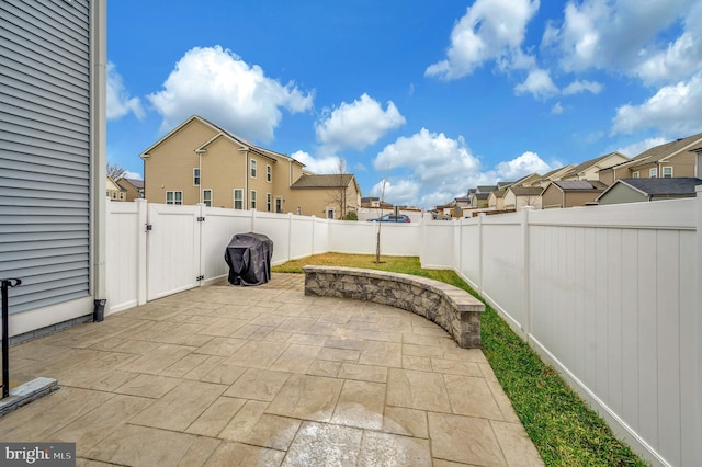 view of patio with a fenced backyard, a gate, and a residential view