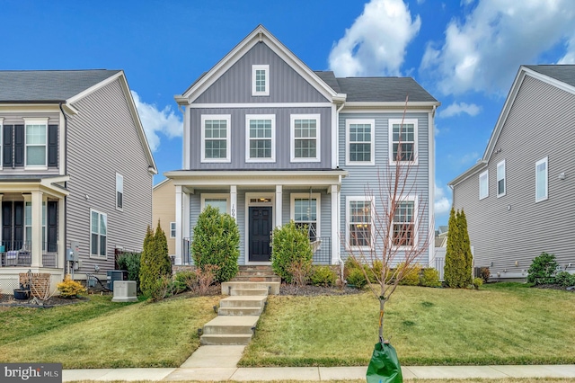 view of front of property featuring central air condition unit, board and batten siding, a porch, and a front yard