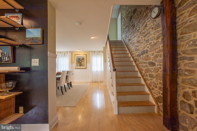 stairs with baseboards and hardwood / wood-style flooring