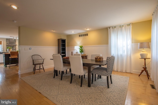 dining space featuring recessed lighting, wainscoting, light wood finished floors, and visible vents