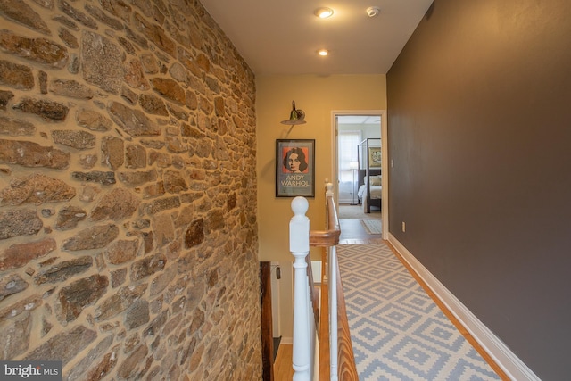 hallway with recessed lighting and an upstairs landing