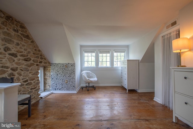 additional living space featuring lofted ceiling, hardwood / wood-style flooring, and visible vents
